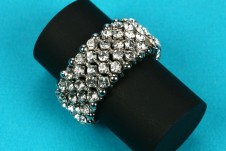 Indulgence elasticated ring with band of diamante clusters